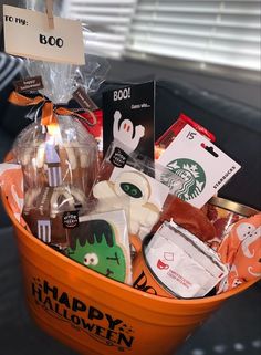 an orange bucket filled with halloween treats and gifts for someone's booze party