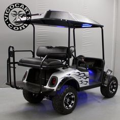 a white and black golf cart with blue lights