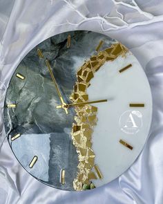 a clock with gold and silver paint on it