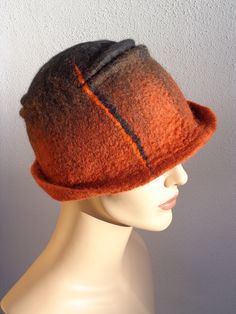 Assymetrical retro hat, brown and black felt cloche, 1920s inspired hat, art deco fashion, 20s accessory, winter hat. This woman felt cloche hat is made of 100% merino wool. It has been felted by hand. The shape is assymetrical and the colour combination is subtile, with black, brown and orange tones. It is a comfortable cloche, soft and light, inspired by the 20s fashion. A great retro accessory, easy to wear everyday! ** Turnaround time ** It will take 3-5 days to re-create a model similar to Cappello Cloche, Felted Hats, Retro Hat, Felted Hat, Hat Art, Felt Fashion, Deco Fashion, Flapper Hat, Retro Hats