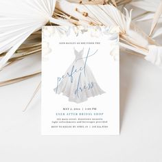 a wedding dress bridal party card on top of palm leaves