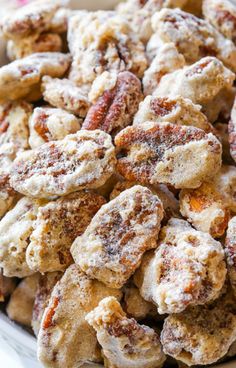 powdered sugar coated doughnuts piled on top of each other