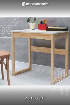 a desk with a chair next to it in front of a gray wall and white floor