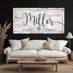 a living room with a white couch and wooden sign on the wall above it that says miller