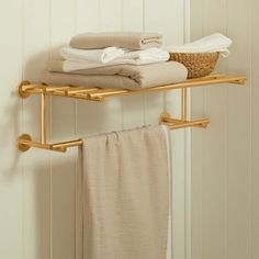 two gold towel racks with towels on them