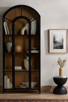 a wooden shelf with vases and other items on it