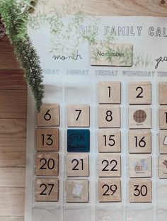 a wooden calendar with numbers and plants on it