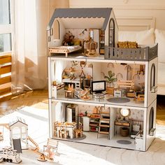 a doll house with furniture and accessories on the floor