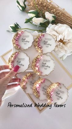 the wedding favors are decorated with pink and gold glitters