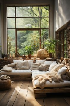 a living room filled with lots of furniture next to a large window covered in plants