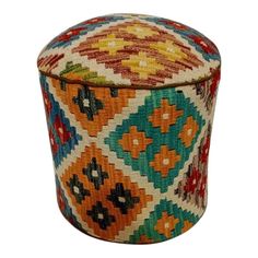 a multicolored round ottoman sitting on top of a white floor