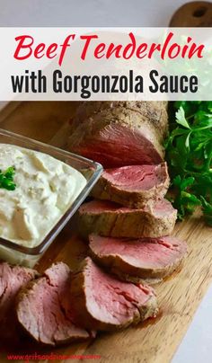 beef tenderloin with gorgonzola sauce on a cutting board next to parsley