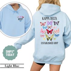 a blue hoodie with butterflies on it and the words kapp delta established 1897