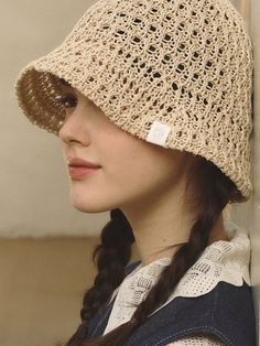 a woman wearing a crocheted hat with a tag on it's ear