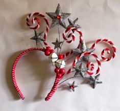 an ornament made out of candy canes and star shaped ornaments on a white background