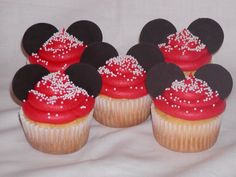 mickey mouse cupcakes with red frosting and white sprinkles on them