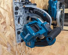 a cordless circular saw is being used on a piece of wood in a workshop