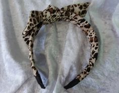 This lovely headband is made from a band bound with an animal-print fabric. Then I added a bow in the same fabric. This bow can be untied or will just slide off if you want to wear the band without it and can be replaced just as easily. The ends of the band have been finished in vlack grosgrain ribbon. The width of the band is 25mm (approximately 1 inch). FREE SHIPPING! Half Price Sale, Leopard Hair Bow, Leopard Print Bow, Animal Print Fabric, Turban Headbands, Headbands For Women, Turbans, Hair Accessories Headbands, Grosgrain Ribbon