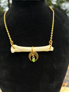 Necklace featuring genuine coyote foot bone with crescent moon & faux peridot gemstone. Comes on gold tone steel chain with a lobster claw clasp. Necklace is approximately 17.5 inches long. Cruelty free - Ethically sourced As the materials used come from nature they can be delicate. They may break if bent or smashed. It is advised that you not submerge them in water for long periods of time (wearing while swimming, showering, etc) as this may cause the materials to weaken or break down. Moon Gold Necklace, Moon Gold, Vulture Culture, Bone Necklace, Clasp Necklace, Jewelry Techniques, Peridot Gemstone, Wedding Jewellery Necklace, Jewelry Inspo