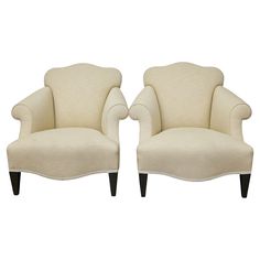 a pair of white chairs sitting next to each other