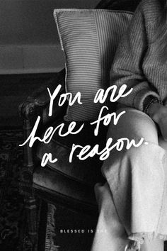 a woman sitting in a chair with her legs crossed and the words you are here for a reason