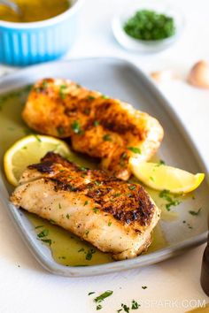 grilled chicken with lemon and parsley on a plate