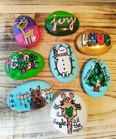 six painted rocks with different designs on them