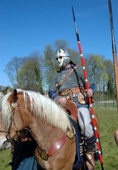 a man in armor riding on the back of a horse