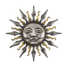 a metal sun face with two knives sticking out of it's center, on a white background