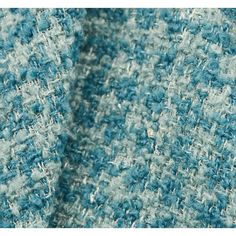 closeup of the texture of a blue and white tweed fabric, with very little detail