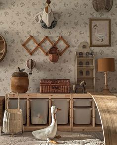 a duck sitting on top of a bed next to a wooden shelf filled with baskets