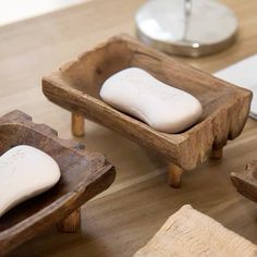 three wooden trays with white soap on top of them next to a computer mouse