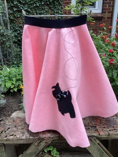 Made from a size 6 Simplicity pattern, this skirt measures 20.5" long. The waistband is a soft, black, 1.5" wide elastic. The waistband fits a 22-28" waist. I used a pink felt to make this skirt. Near the bottom I ironed on a black Scottie dog. I stitched on a black leash and attached a black with white dots bow at the dogs neck.  This circle skirt would be cute as a Halloween costume, fun for dress up, or for any 50's event you plan! Pink Stretch Skirt With Elastic Waistband, Long Pink Skirt With Elastic Waistband, Pink Full Skirt With Elastic Waistband, Pink Party Skirt With Elastic Waistband, Fitted Full Skirt With Elastic Waistband, Fitted Pink Skirt With Elastic Waistband, Pink Fitted Skirt With Elastic Waistband, Pink Fitted Full Skirt, Pink Stretch Full Skirt