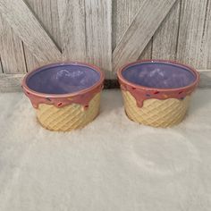 two ice cream containers sitting next to each other