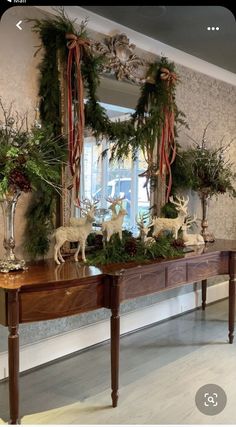 a table with christmas decorations and deer on it