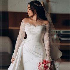 a woman in a wedding dress holding a bouquet