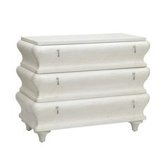 a white chest with three drawers on it