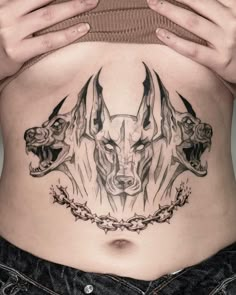 a woman's stomach with an animal tattoo on it