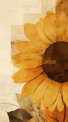 a large yellow sunflower sitting on top of a wooden table