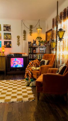 a living room filled with furniture and a flat screen tv sitting on top of a hard wood floor