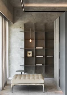 a living room filled with furniture and bookshelves