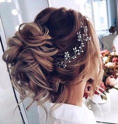 a woman wearing a hair comb with flowers in the background and a mirror behind her