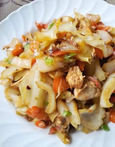 a white plate topped with pasta and meat