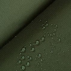 drops of water are on the green fabric