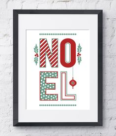 a framed poster with the word noel written in red, green and white letters on it