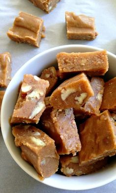 a white bowl filled with peanut butter fudges on top of a gray table