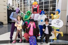 group of people dressed up in costumes posing for the camera