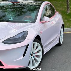 a white and pink car is parked on the street