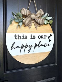 this is our happy place sign hanging on the front door