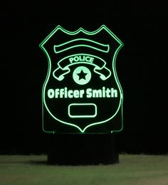 a police officer sign lit up in the dark